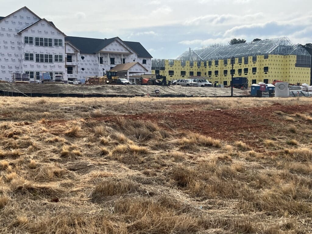 view of community construction site from field