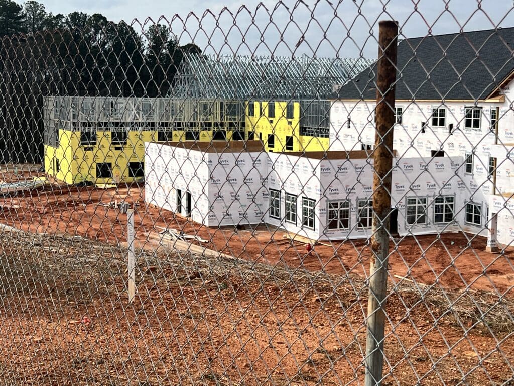 view of community under construction from behind fence