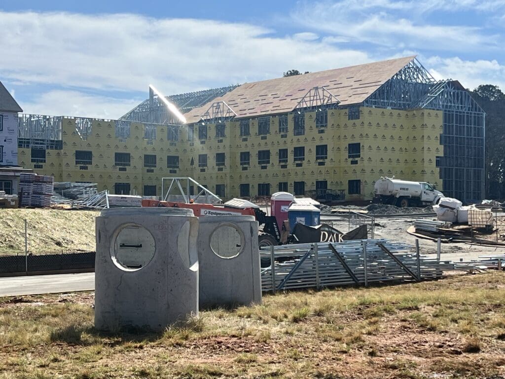 construction materials in front of frame of community building