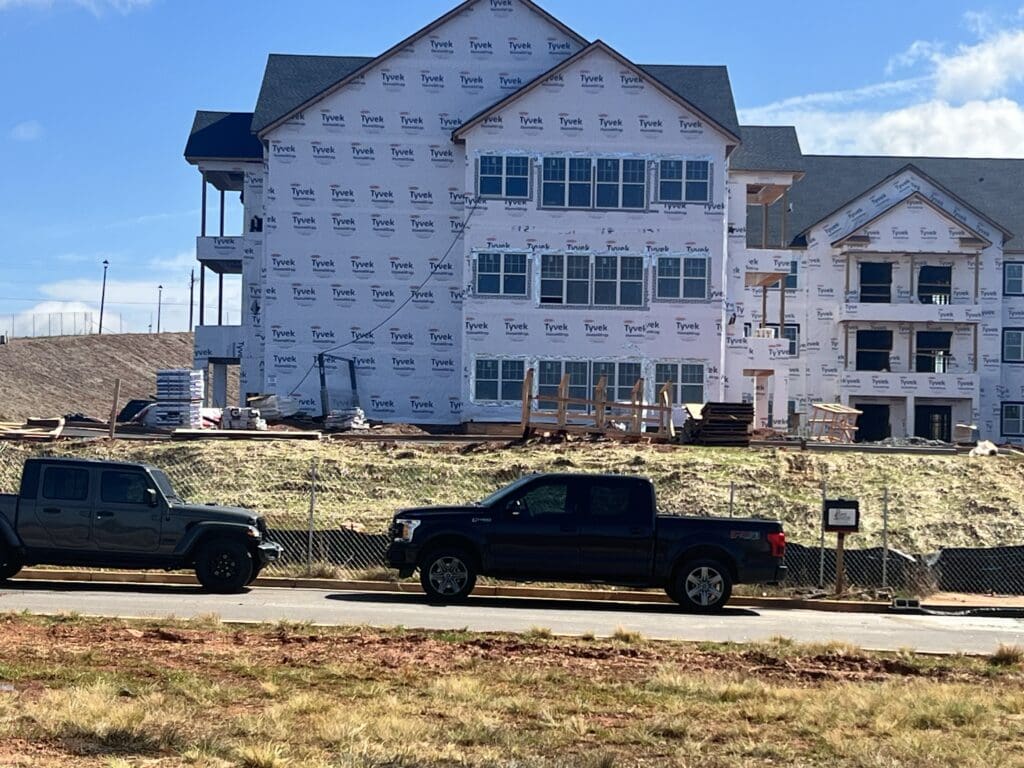construction area of community buildings, view of road with parked vehicles