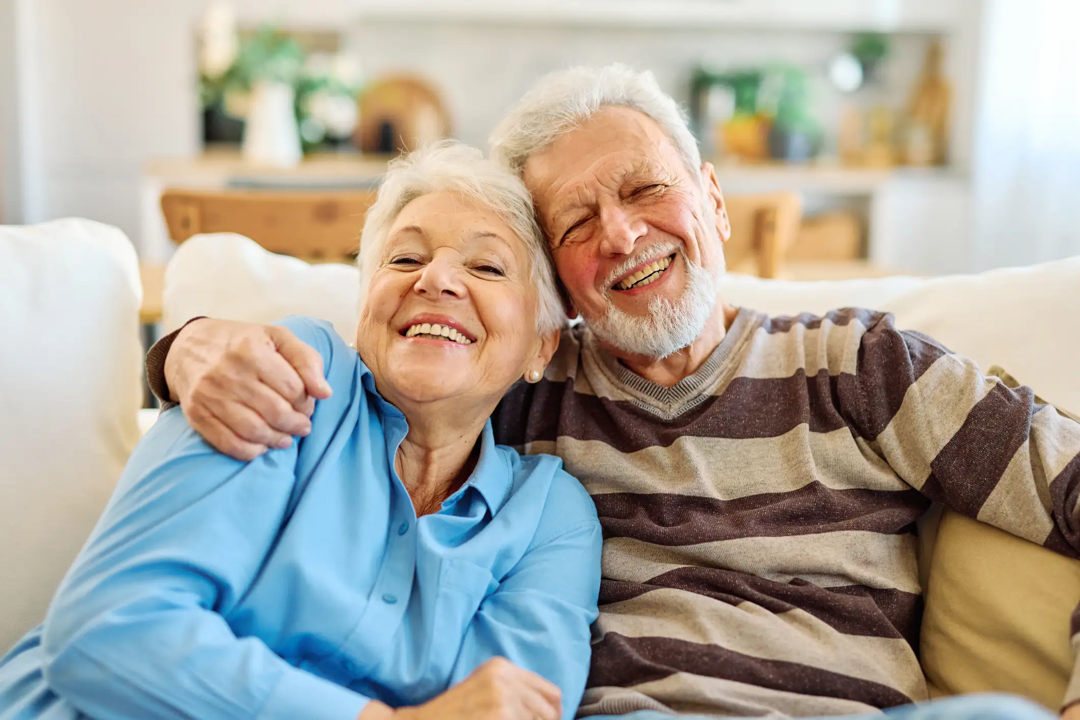 Portrait of a happy couple smiling and hugging while contemplating choosing assisted living in Winder, GA.